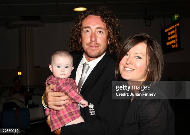 Ryan Sidebottom of England with partner and baby return at Gatwick Airport on May 18, 2010 in London, England.
