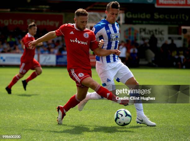 Jordan Clark of Accrington Stanley and Jonathan Hogg of Huddersfiled Town battle for the ball during the pre-season friendly between Accrington...