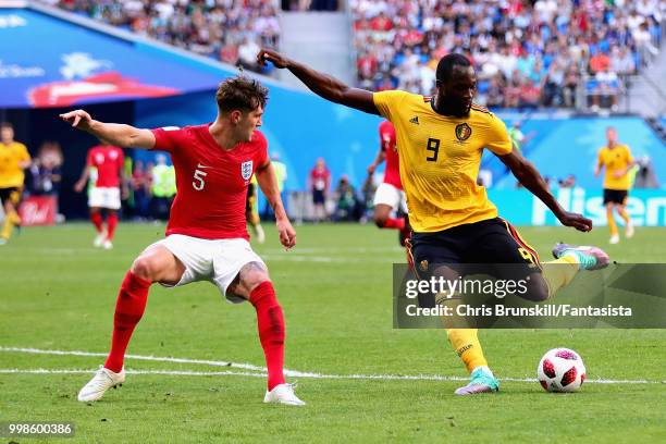 Romelu Lukaku of Belgium takes a shot as John Stones of England tries to block during the 2018 FIFA World Cup Russia 3rd Place Playoff match between...