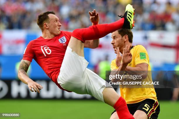 England's defender Phil Jones makes a bicycle kick past Belgium's defender Jan Vertonghen during their Russia 2018 World Cup play-off for third place...