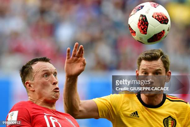 England's defender Phil Jones eyes the ball with Belgium's defender Jan Vertonghen during their Russia 2018 World Cup play-off for third place...