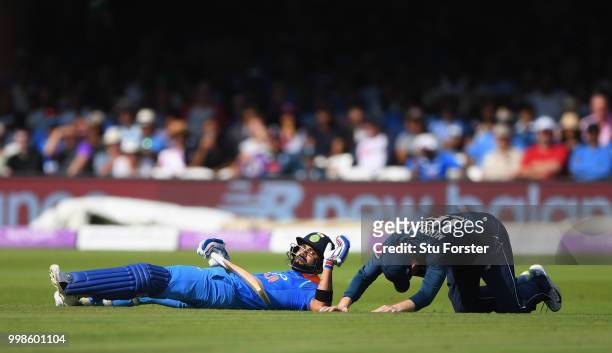India batsman Virat Kohli and Eoin Morgan react after colliding during the 2nd ODI Royal London One Day International match between England and India...
