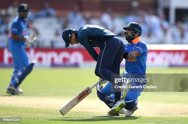 India captain Virat Kohli collides with England captain Eoin Morgan during the 2nd ODI Royal London One-Day match between England and India at Lord's...