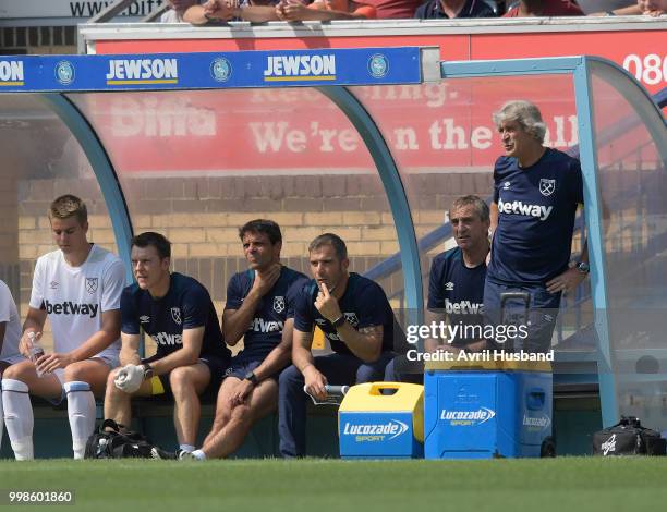 Manuel Pellegrini of West Ham United watches on from the dugout during the pre season friendly between Wycombe Wanderers and West Ham United at Adams...