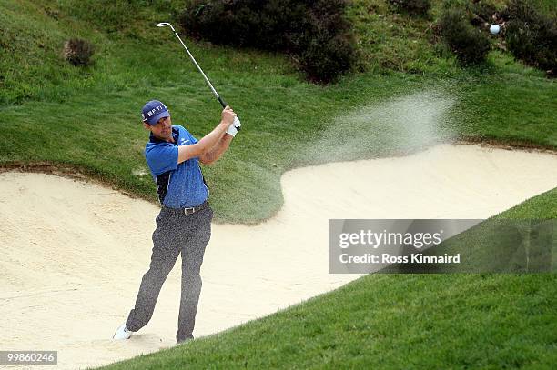 Padraig Harrington of Ireland hits from a bunker on the par three second hole during a practice round at Wentworth prior to the BMW PGA Championship...