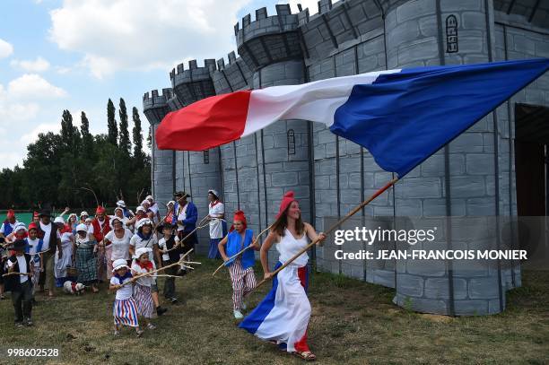 Villager dressed as Marianne, personification of the French Revolution, performs during Bastille Day celebrations on 14 July 2018 in Lavaré, western...