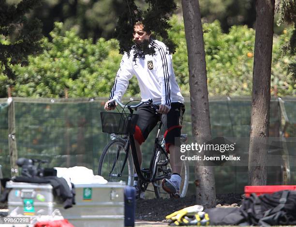 Manuel Neuer of Germany rides a bike prior to the German National Team training session at Verdura Golf and Spa Resort on May 18, 2010 in Sciacca,...