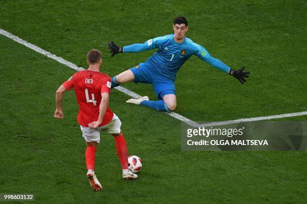 England's midfielder Eric Dier knocks the ball over Belgium's goalkeeper Thibaut Courtois during their Russia 2018 World Cup play-off for third place...