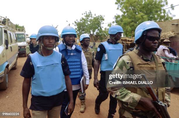 Members of the United Nations Multidimensional Integrated Stabilization Mission in Mali, patrol in the town of Konna on July 5, 2018. - From torched...