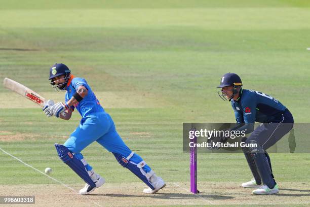 Virat Kohli of India plays a shot as wicketkeeper Jos Buttler of England looks on during the 2nd Royal London One day International match between...