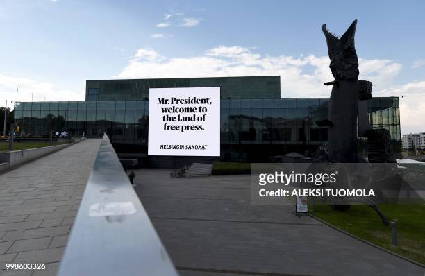 Picture taken on July 14, 2018 shows a board reading "Mr. President, welcome to the land of free press" and displayed by Finnish newspaper Helsingin...