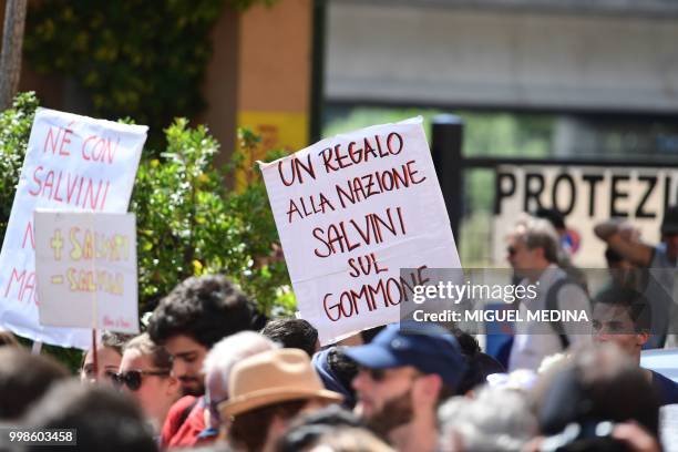 Board reads " A gift to the nation: Salvini on an inflatable boat" during a demonstration at the call of an Italian association "Progetto 20K" to...