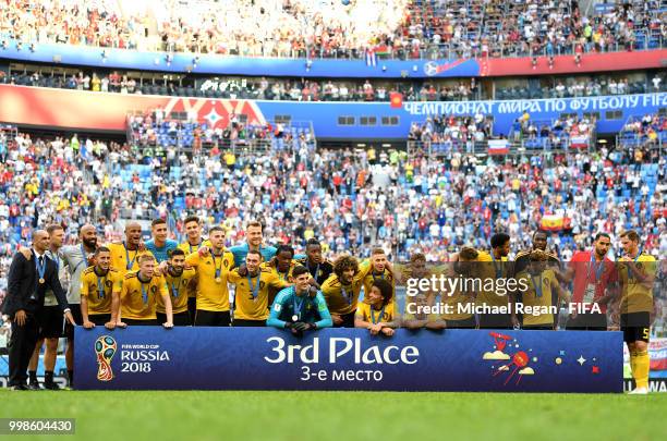 Belgium players pose for a photo after recieving their third place medals during the 2018 FIFA World Cup Russia 3rd Place Playoff match between...