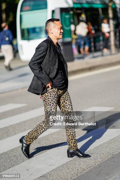 Guest wears a black blazer jacket, leopard print pants, black leather shoes, outside Dries Van Noten, during Paris Fashion Week - Menswear...