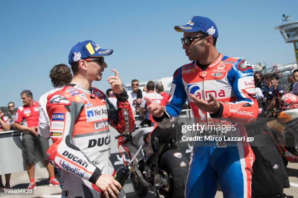 Danilo Petrucci of Italy and Alma Pramac Racing speaks with Jorge Lorenzo of Spain and Ducati Team at the end of the qualifying practice during the...