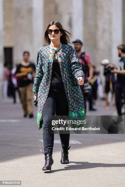 Guest wears a green jacket with printed patterns, black pants, outside Lanvin, during Paris Fashion Week - Menswear Spring-Summer 2019, on June 24,...