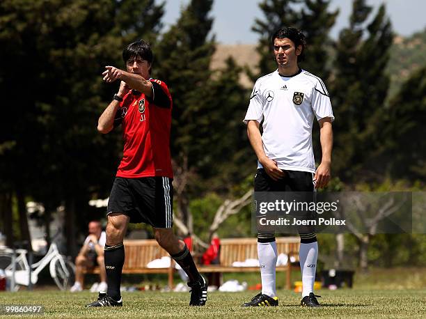 Head coach Joachim Loew of Germany instructs Serdar Tasci during the German National Team training session at Verdura Golf and Spa Resort on May 18,...