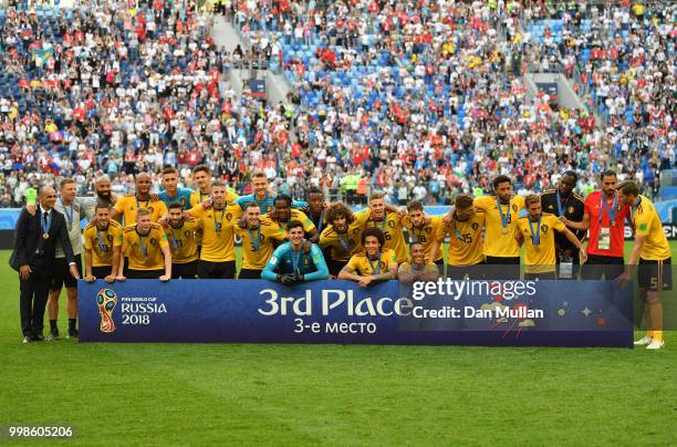 Belgium players pose for a photo after recieving their third place medals during the 2018 FIFA World Cup Russia 3rd Place Playoff match between...