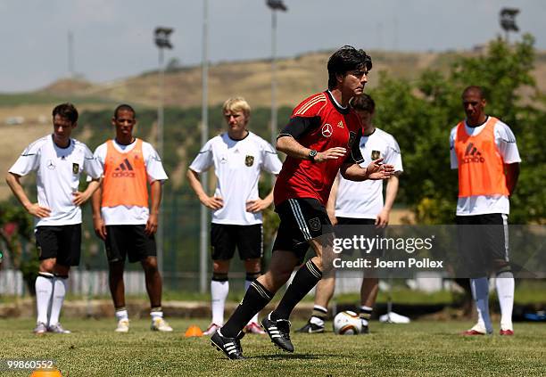 Head coach Joachim Loew of Germany is running during the German National Team training session at Verdura Golf and Spa Resort on May 18, 2010 in...