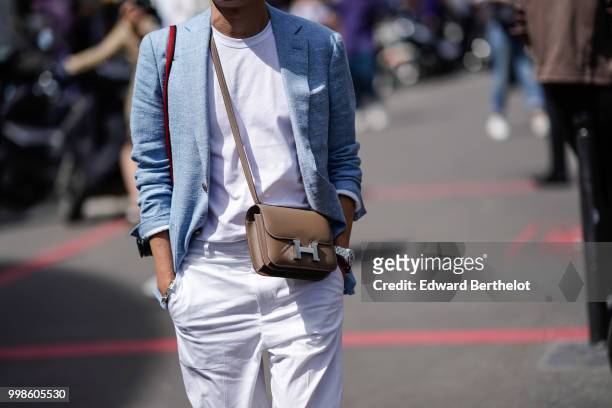 Guest wears a blue blazer jacket, a white t-shirt, a brown Hermes bag, outside Lanvin, during Paris Fashion Week - Menswear Spring-Summer 2019, on...