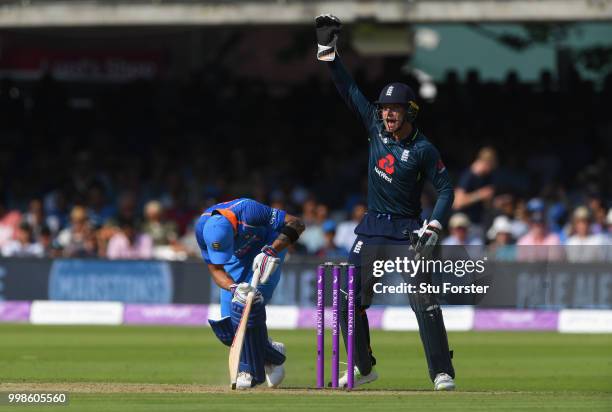 India batsman Virat Kohli looks on as Jos Buttler appeals with success for his wicket off the bowling of Moeen Ali during the 2nd ODI Royal London...