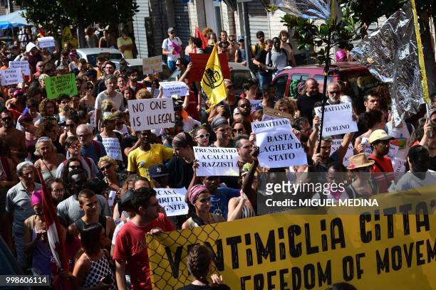 People participate at a demonstration at the call of an Italian association "Progetto 20K" to help migrants in Vintimille, northern Italy, close to...