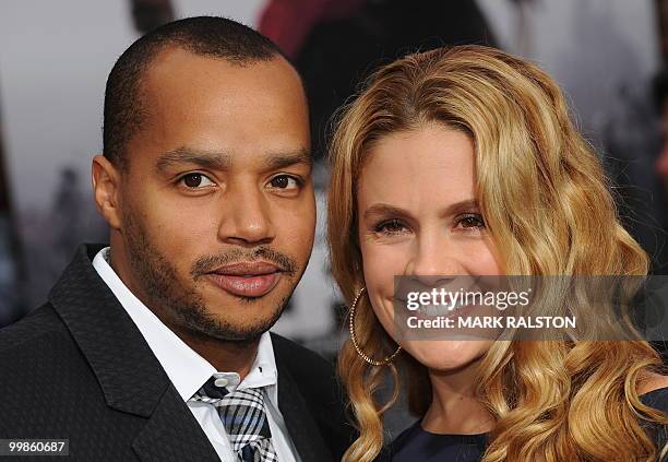 Actor Donald Faison and partner pose on the red carpet as they arrive for the premiere of "Prince of Persia: The Sands of Time" at Grauman's Chinese...