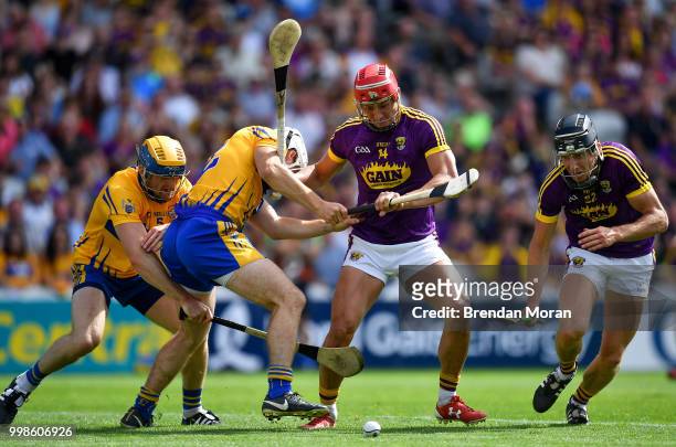 Cork , Ireland - 14 July 2018; Lee Chin, centre, and Liam Óg McGovern of Wexford in action against Seadna Morey, left, and Patrick O'Connor of Clare...