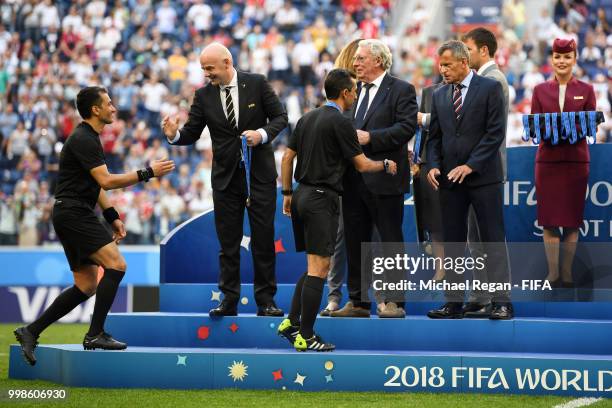 Referee Alireza Faghani is awarded by FIFA President Gianni Infantino, General Secretary of the Royal Belgian Football Association Gerard Linard and...