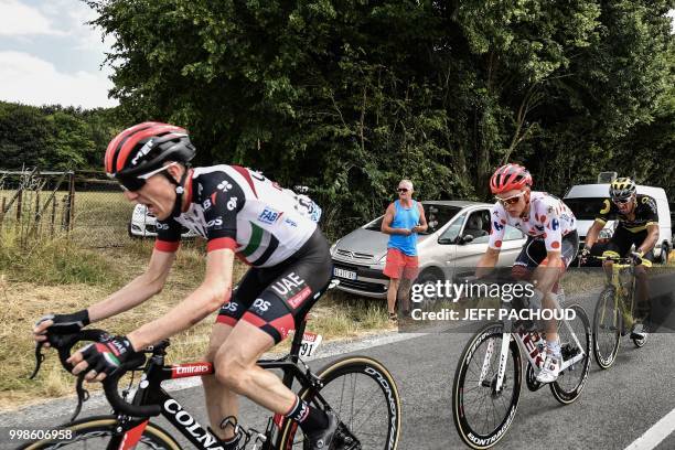Ireland's Daniel Martin and Latvia's Toms Skujins get going again after being caught in a crash during the eighth stage of the 105th edition of the...
