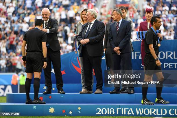 Referee Alireza Faghani is awarded by FIFA President Gianni Infantino, General Secretary of the Royal Belgian Football Association Gerard Linard and...