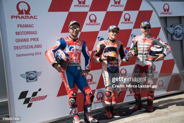 Danilo Petrucci of Italy and Alma Pramac Racing, Marc Marquez of Spain and Repsol Honda Team and Jorge Lorenzo of Spain and Ducati Team celebrate at...