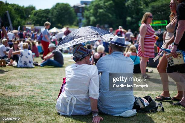 Couple shelter from the sun under an umbrella during the 134th Durham Miners' Gala on July 14, 2018 in Durham, England. Over two decades after the...