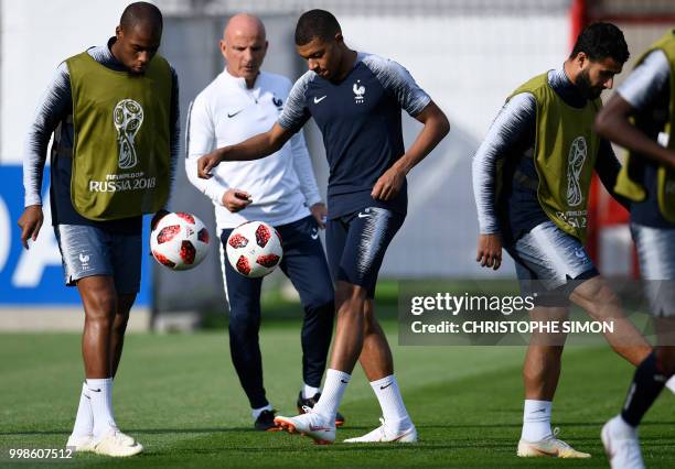 France's defender Djibril Sidibe, France's assistant coach Guy Stephan, France's forward Kylian Mbappe and France's midfielder Nabil Fekir attend a...
