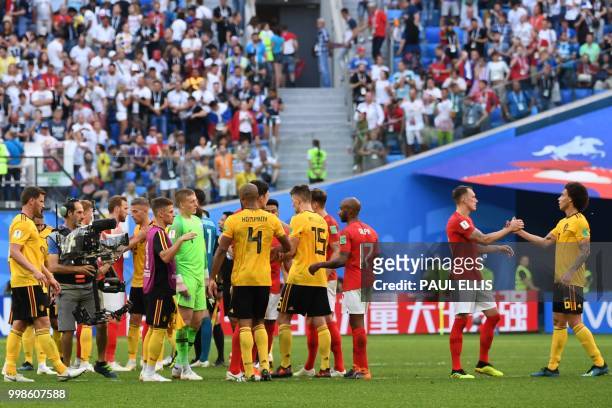 England's defender Phil Jones and Belgium's midfielder Axel Witsel shake hands after their Russia 2018 World Cup play-off for third place football...