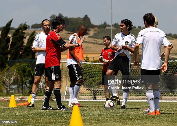 Head coach Joachim Loew of Germany talks to some players during the German National Team training session at Verdura Golf and Spa Resort on May 18,...