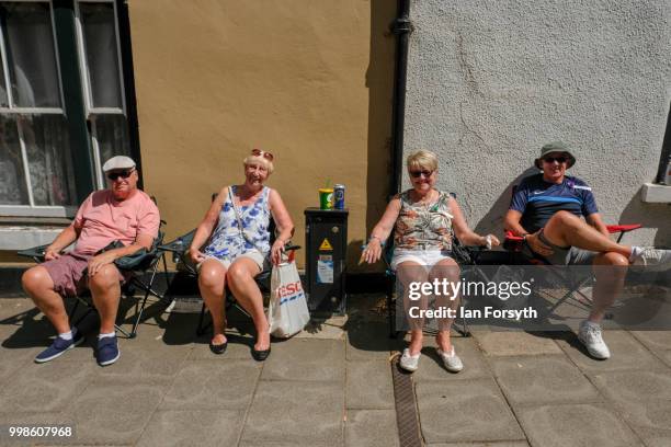 Friends enjopy the atmosphere as they sit watching as colliery bands pass them during the 134th Durham Miners' Gala on July 14, 2018 in Durham,...