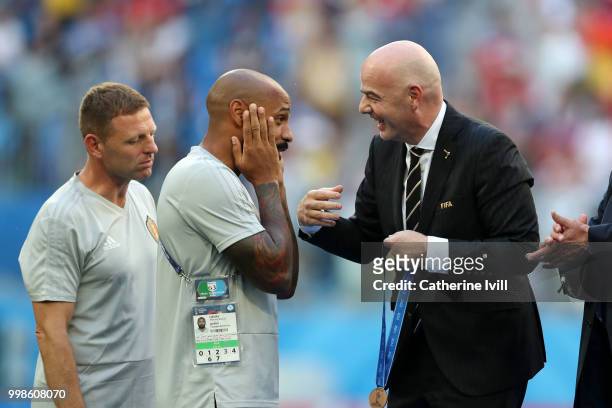 Presifdent Gianni Infantino congratulates Thierry Henry and Gareme Jones, assistant coaches of Belgium during medal ceremony following the 2018 FIFA...