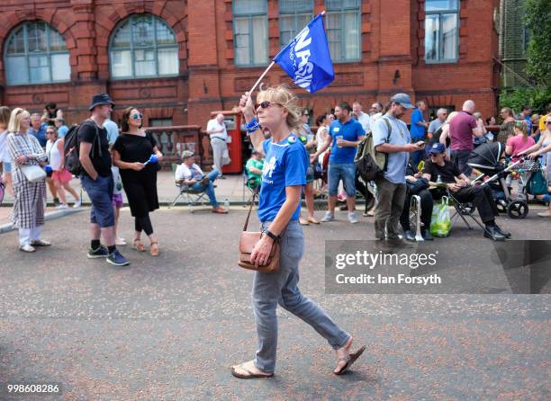 Woman waving a teacher's union flag walks through the streets of Durham during the 134th Durham Miners' Gala on July 14, 2018 in Durham, England....