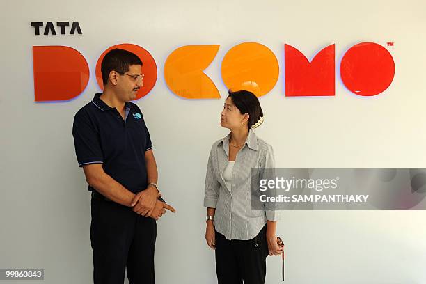 Nipun Sharma , Tata DOCOMO's Chief Operating Officer for Gujarat, interacts with a company employee during the launch of company's first Dive-in...