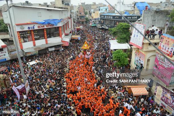 Indian Hindu devotees pull a chariot carrying the icon of Lord Jagannath in Raipur area of Ahmedabad during the 141st annual Rath Yatra of Lord...