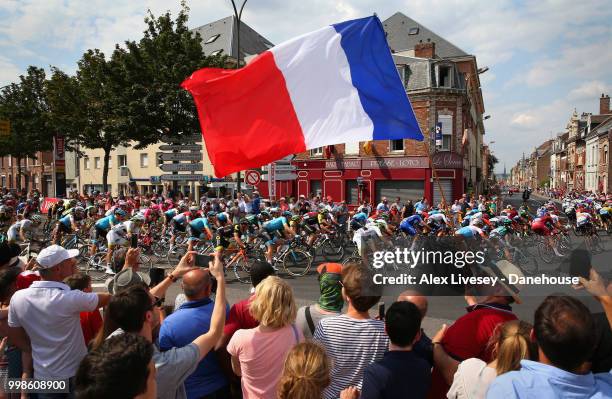 The peloton take a turn 4km before the finish of Stage 8 a 181km stage from Dreux to Amiens Metropole as supporters cheer them on during the 105th...