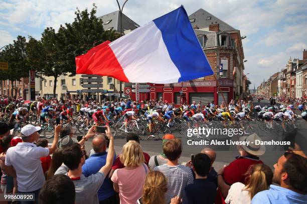 The peloton take a turn 4km before the finish of Stage 8 a 181km stage from Dreux to Amiens Metropole as supporters cheer them on during the 105th...