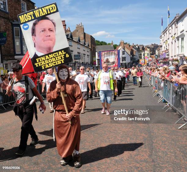 Man dressed as an anonymous monk carries an anti David Cameron placard during the 134th Durham MinersÕ Gala on July 14, 2018 in Durham, England. Over...