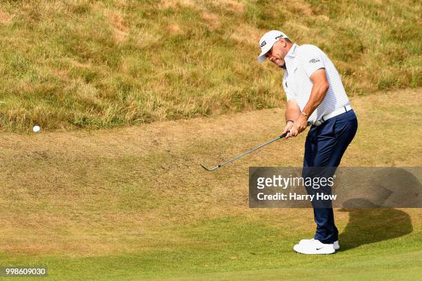 Lee Westwood of England plays a chip on hole one during day three of the Aberdeen Standard Investments Scottish Open at Gullane Golf Course on July...