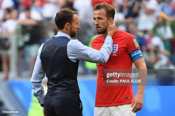 England's coach Gareth Southgate talks to England's forward Harry Kane after losing their Russia 2018 World Cup play-off for third place football...