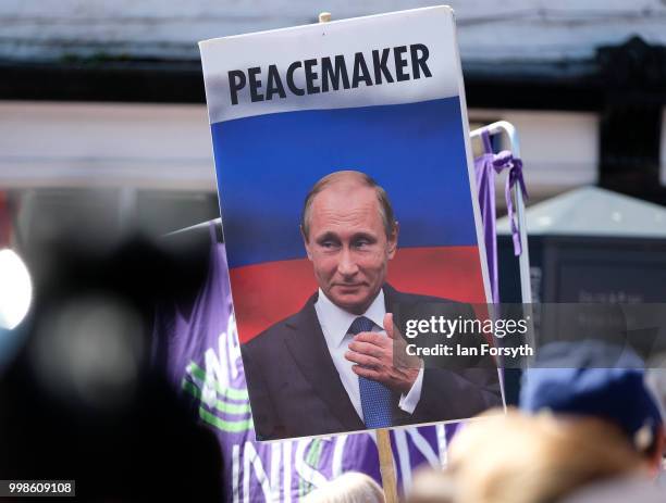 Man carrying a placard depicting President Putin walks through Durham City during the 134th Durham MinersÕ Gala on July 14, 2018 in Durham, England....