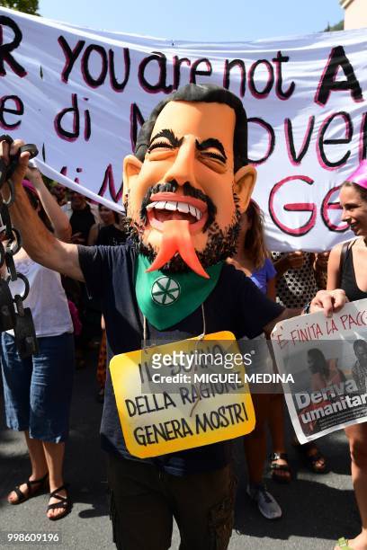 Board reads " A gift to the nation: Salvini on an inflatable boat" during a demonstration at the call of an Italian association "Progetto 20K" to...