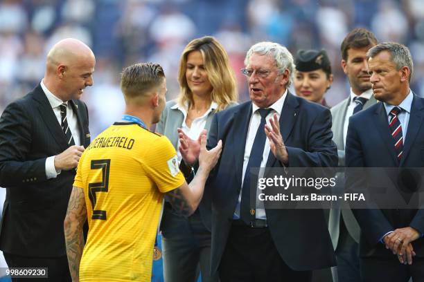 General Secretary of the Royal Belgian Football Association Gerard Linard congratulates Toby Alderweireld of Belgium on the podium prior to medal...