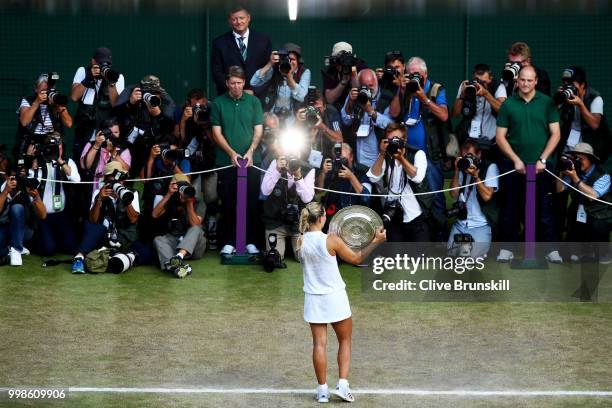 Angelique Kerber of Germany holds the Venus Rosewater Dish as she poses for photographs after defeating Serena Williams of The United States in the...